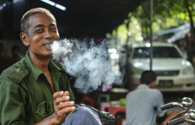 Trishaw Driver smoking cigarette in Yangon, Myanmar
