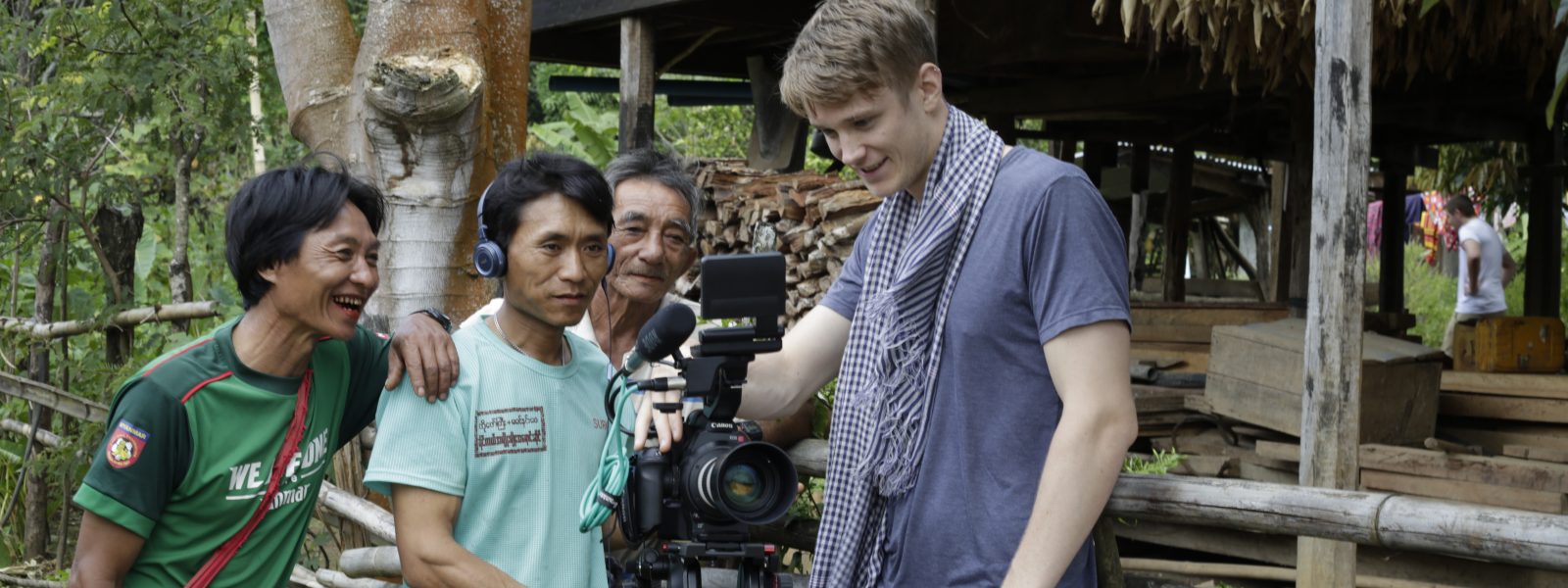 Luke Radcliff and Myanmar men play with professional camera