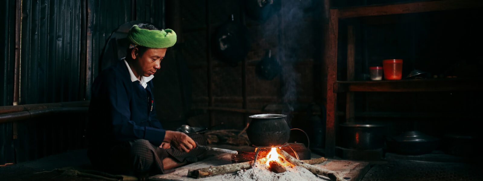 Ko San Tu cooking in his kitchen, Shan State, Myanmar