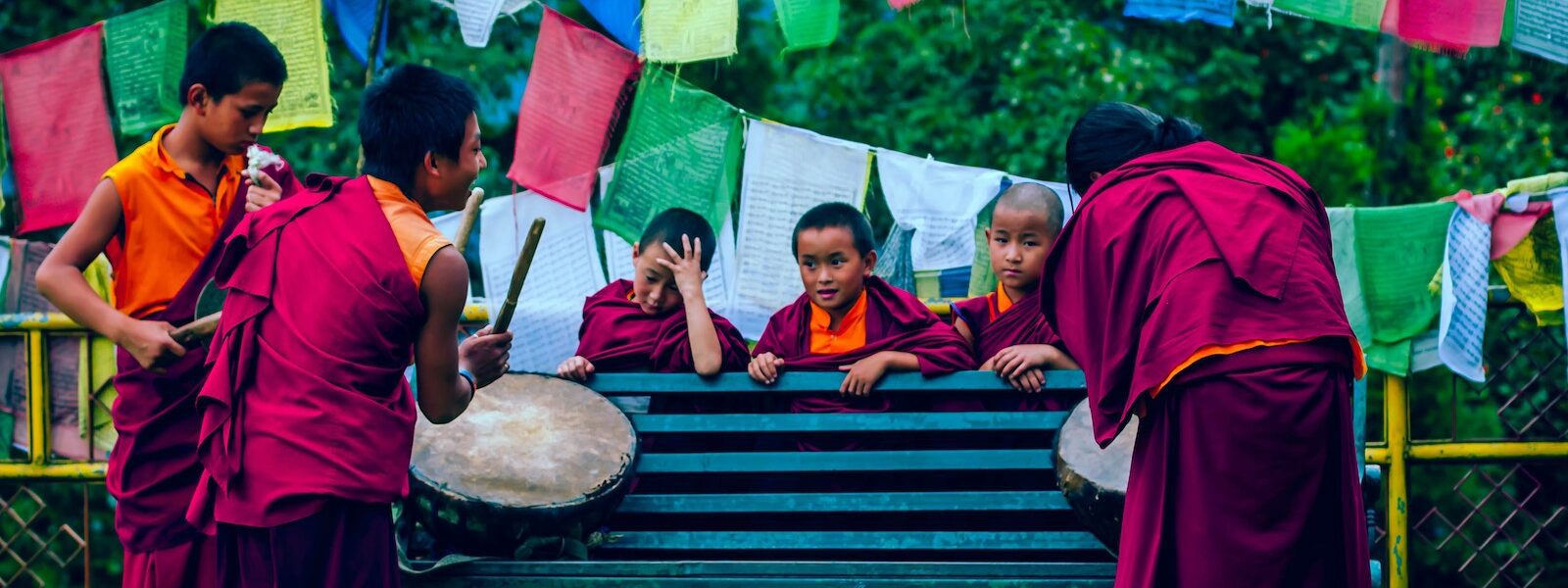 Novice monks in purple playing the drum in Sikkim, India